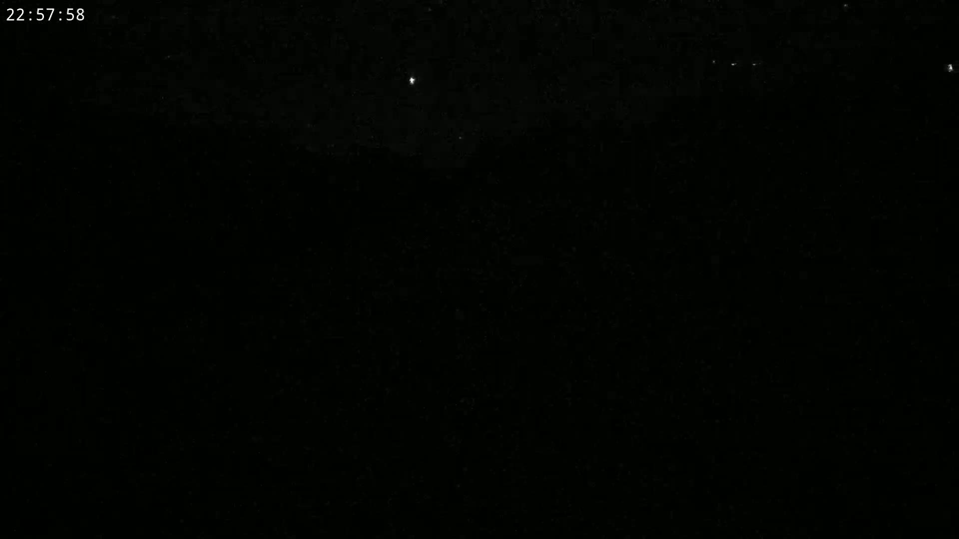 A nighttime outdoor scene shows a dark sky with a few visible stars.