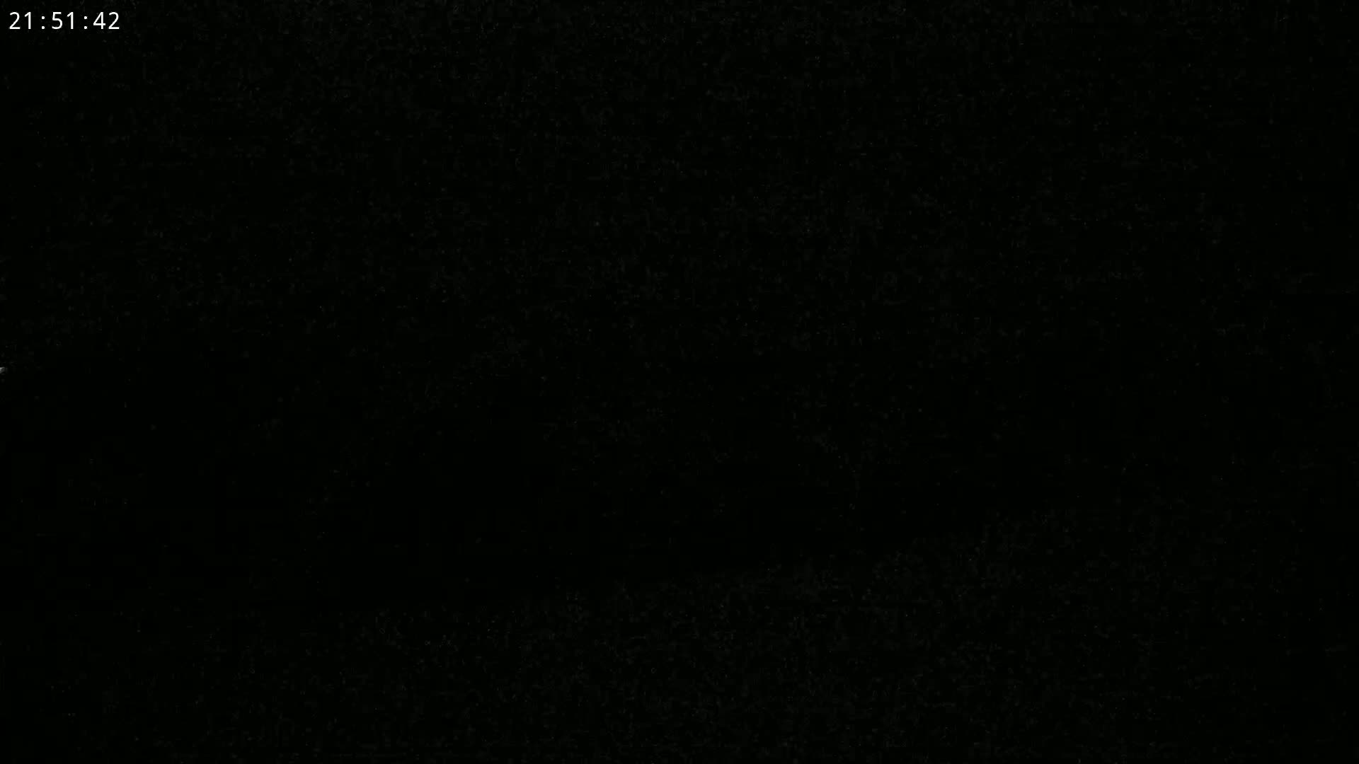 The image is a completely black screen with extremely faint, indistinguishable speckles.