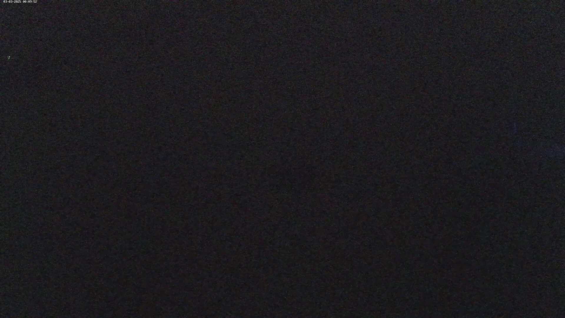 The image shows a completely dark, grainy surface.
