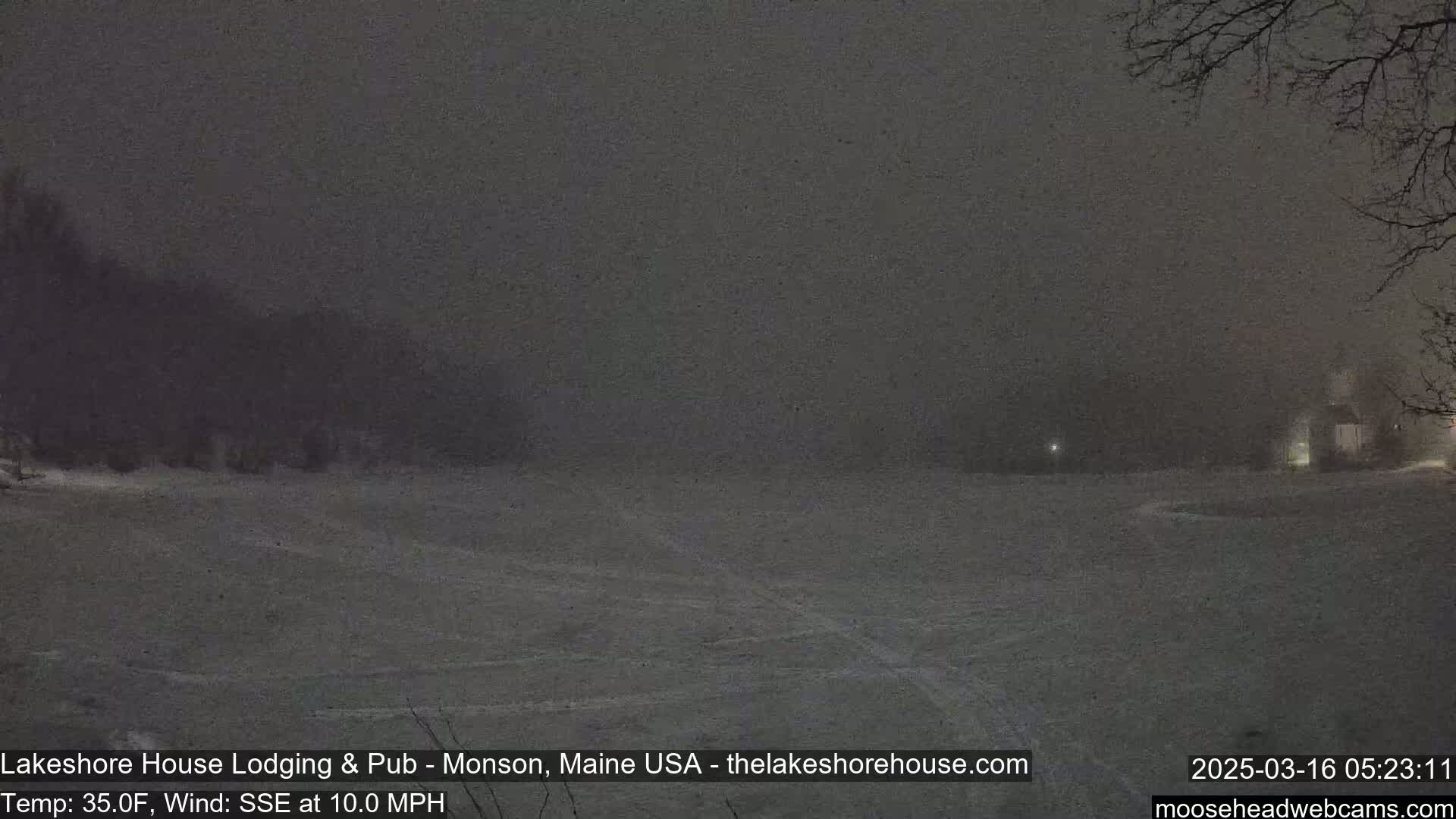 A snow-covered landscape is visible at night under heavy snowfall with a 35°F temperature and a 10 mph wind from the south-southeast.