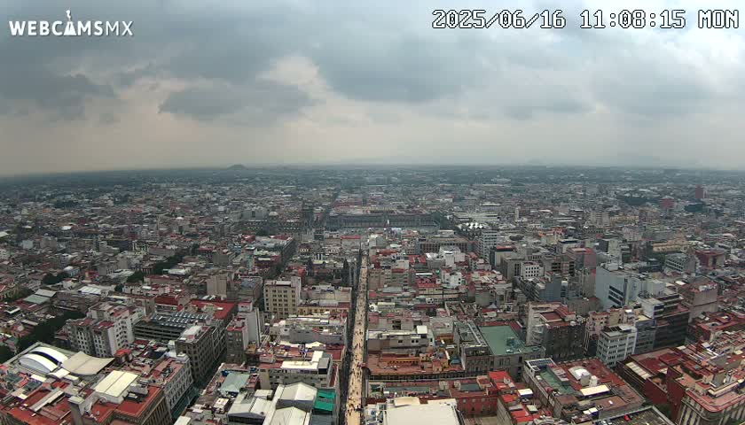 A sprawling cityscape under a cloudy sky stretches to the horizon.