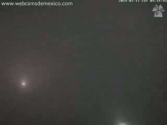 A dimly lit, hazy scene shows a faint light source in the distance.