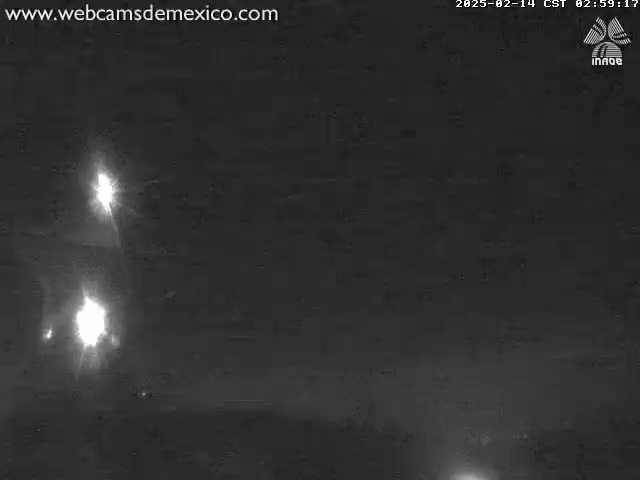 At night, bright lights from what appears to be vehicles are visible in the dark distance.