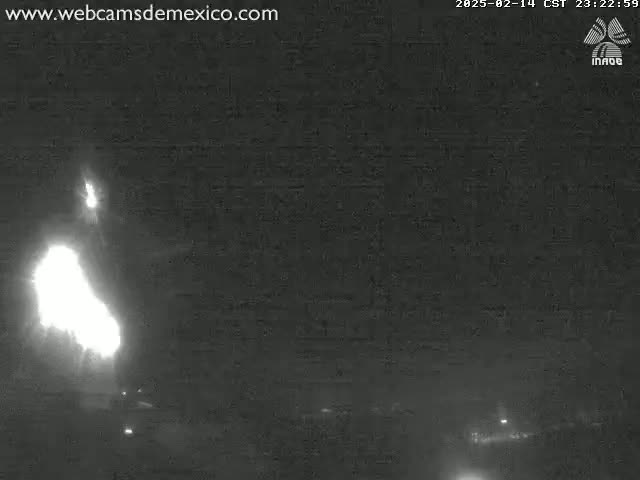 A bright light, possibly a fire or explosion, is visible in the night sky.