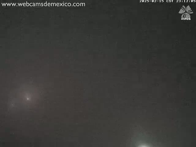 A dark, nighttime sky shows two faint, bright lights.
