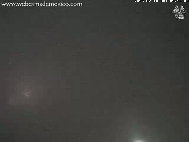 A dark, foggy scene is visible, with a faint light source possibly in the lower right.