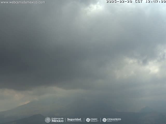 Overcast skies and dark clouds obscure distant mountains.