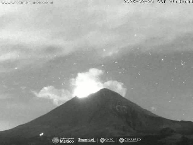 A grayscale image shows a volcano erupting under a nighttime sky filled with stars.