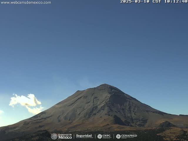 A large, dark gray volcano is visible under a clear blue sky with a single small cloud.