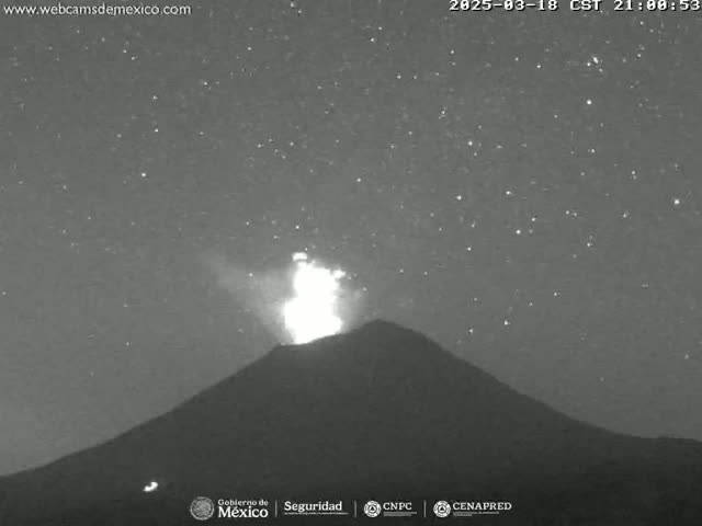 A volcano erupts at night under a starry sky.
