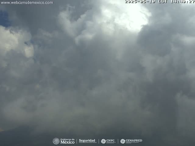 A mostly cloudy sky with some brighter areas breaking through the clouds.