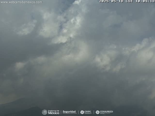 A mostly cloudy sky with dark gray clouds dominating the image, suggesting an overcast day potentially with light rain or drizzle.