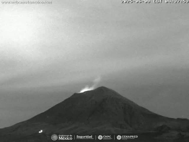 A grayscale image shows a volcano erupting under an overcast sky.