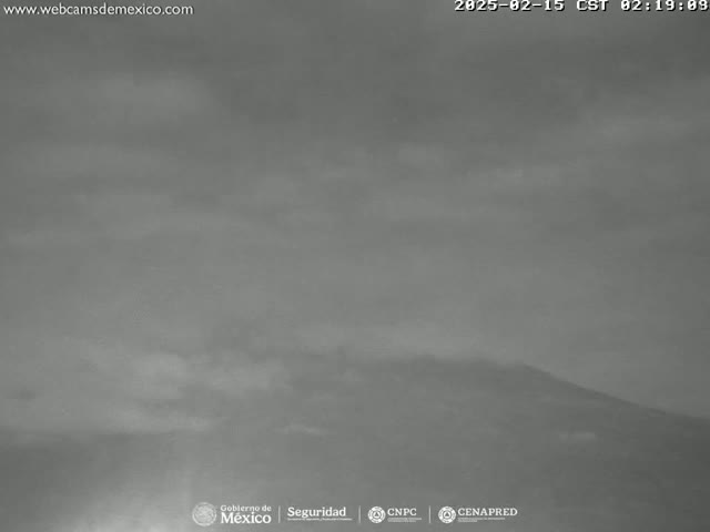 A low-light, overcast view shows a distant mountain range.
