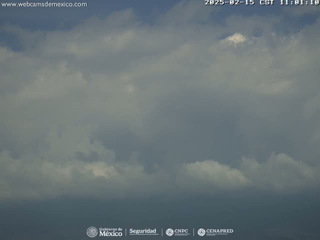 An overcast sky with mostly gray and white clouds is visible.