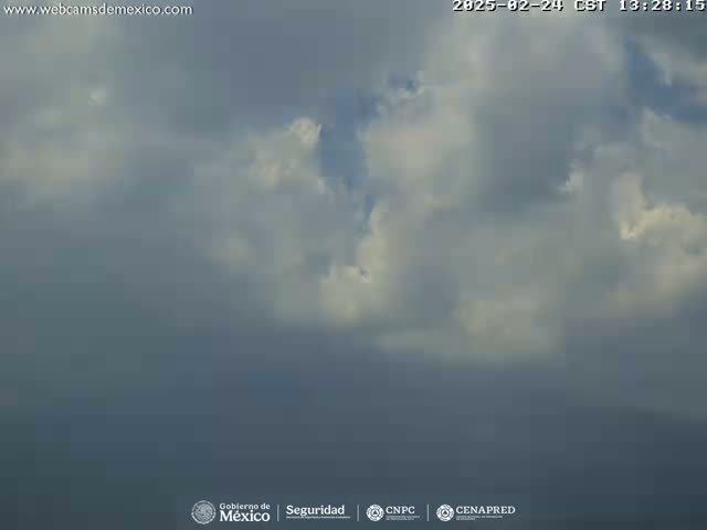 A mostly cloudy sky with some brighter, puffy clouds visible.