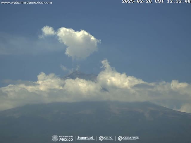 A partially cloudy sky partially obscures a large, distant mountain.