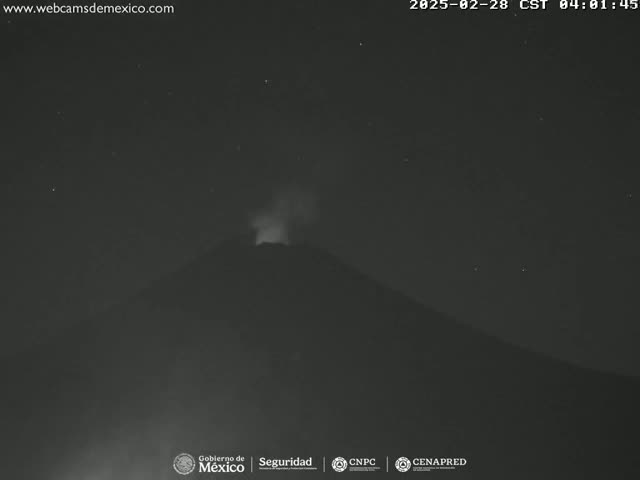 A nighttime view shows a volcano erupting under a clear, starry sky.