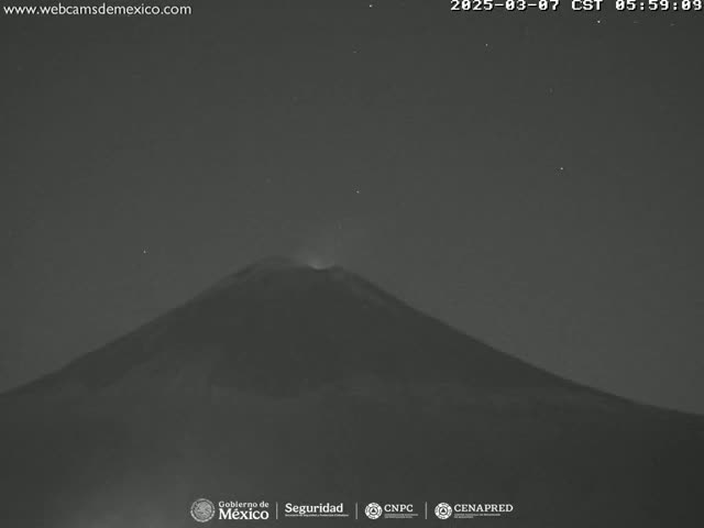 A dark, large volcano is visible at night under a clear, starry sky.