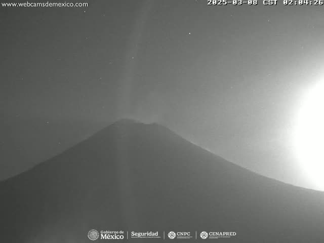 A dark, possibly volcanic, mountain is visible under a night sky with a few stars and a bright light source in the upper right corner.