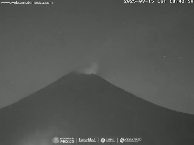 A dark, possibly volcanic mountain is shown at night under a clear, starry sky, with a faint glow emanating from its peak.