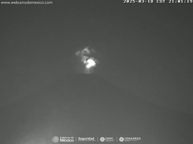 A nighttime, low-light image shows a faint, bright plume rising into a dark sky.