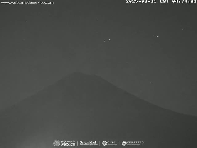 A dark, mountainous landscape is visible under a clear, starlit night sky.