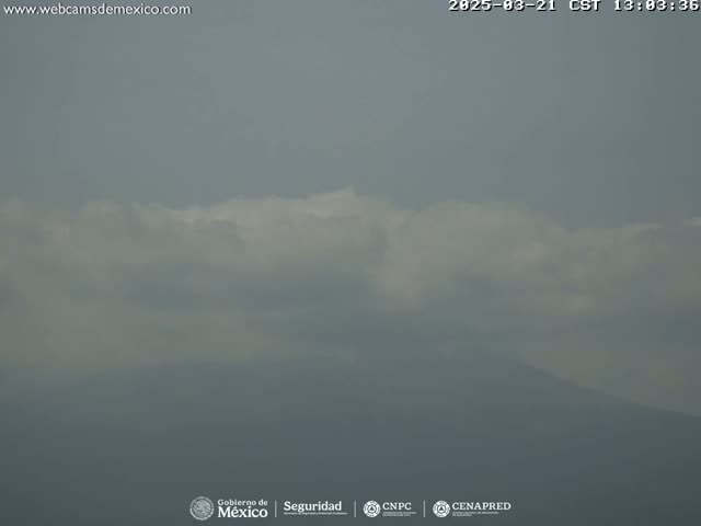 A hazy, overcast sky hangs over a distant mountain range.