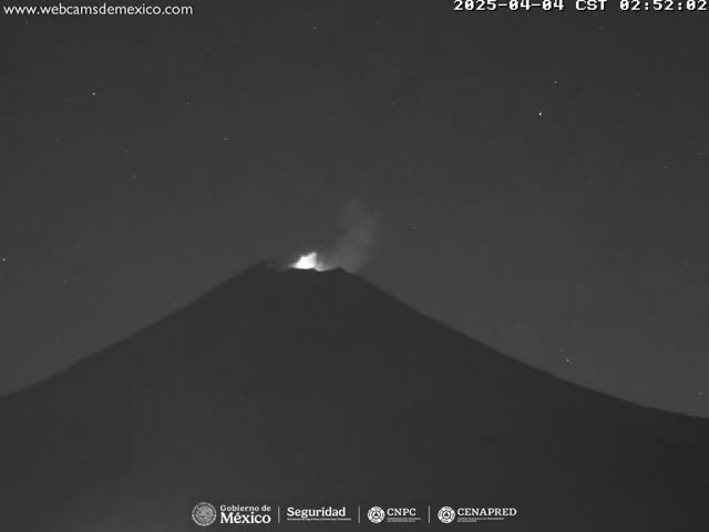 A volcano erupts under a clear, starry night sky.