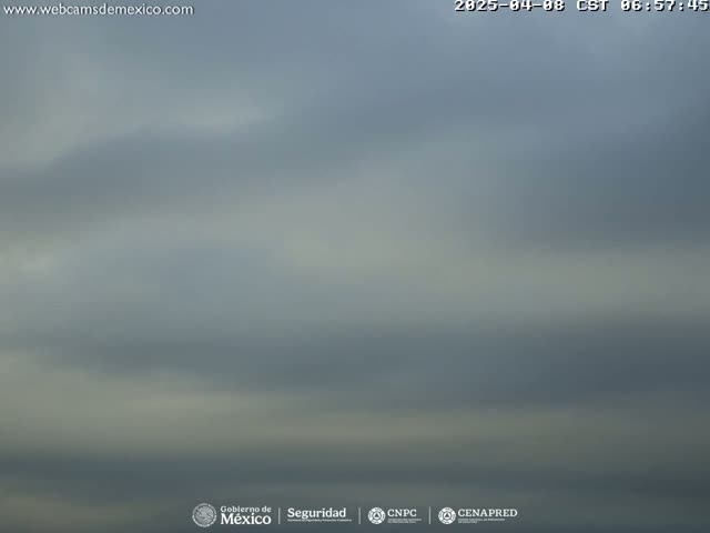 A mostly cloudy sky is visible with muted gray and white hues.