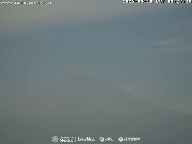 A hazy, distant mountain is visible under a mostly clear sky.