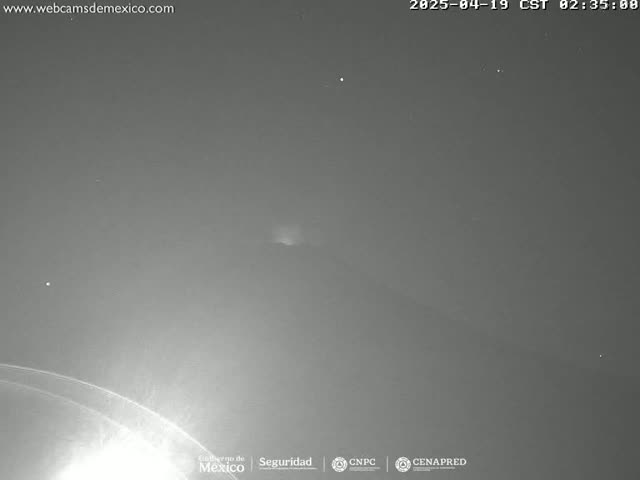 A nighttime outdoor image shows a faint, distant lightning strike in a dark, clear sky.