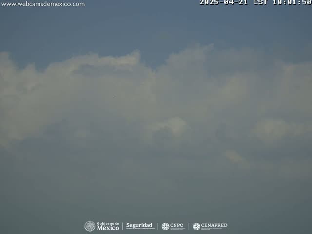 A mostly cloudy sky with a few patches of blue visible.