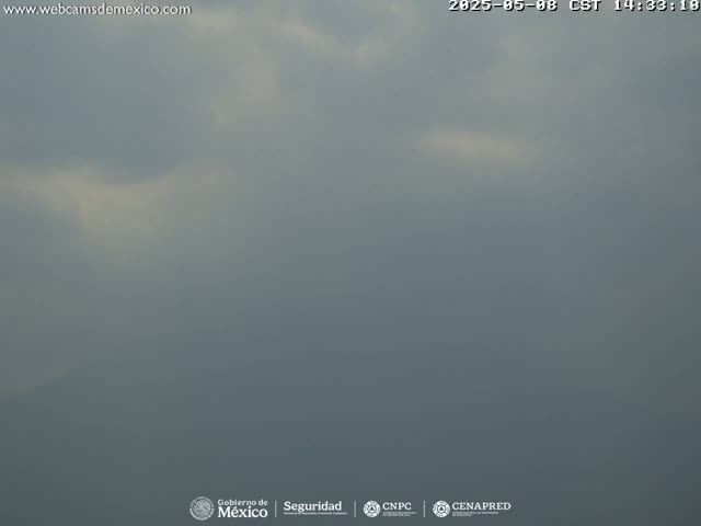 A hazy, overcast sky obscures a distant landscape under cloudy conditions.