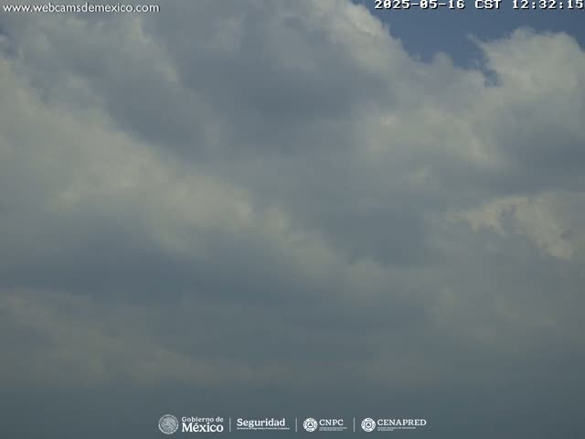 A mostly cloudy sky is visible, with varying shades of gray and white clouds.