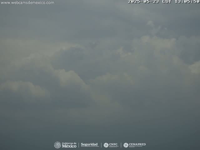 A mostly cloudy sky is visible, with varying shades of gray and white clouds.