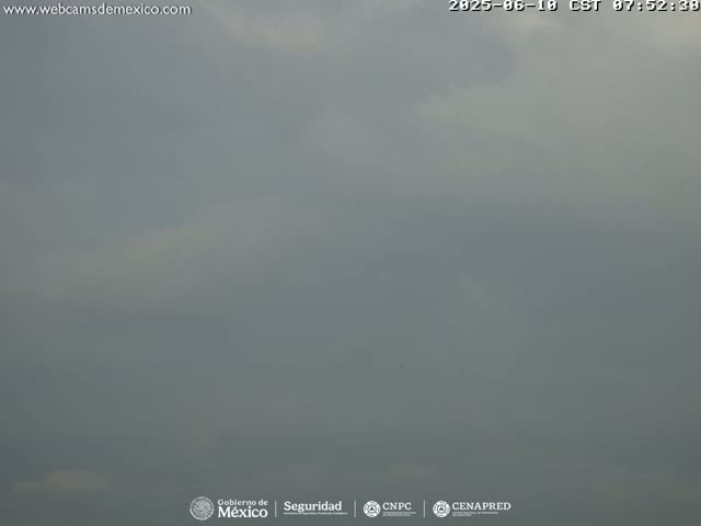 A mostly overcast sky is visible, with a hazy atmosphere.