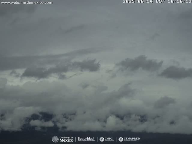 A mostly cloudy sky, with a dark, overcast appearance.