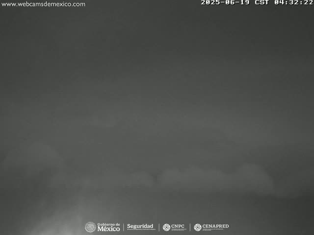 A dark, overcast sky is visible, with low-hanging clouds obscuring any clear view.