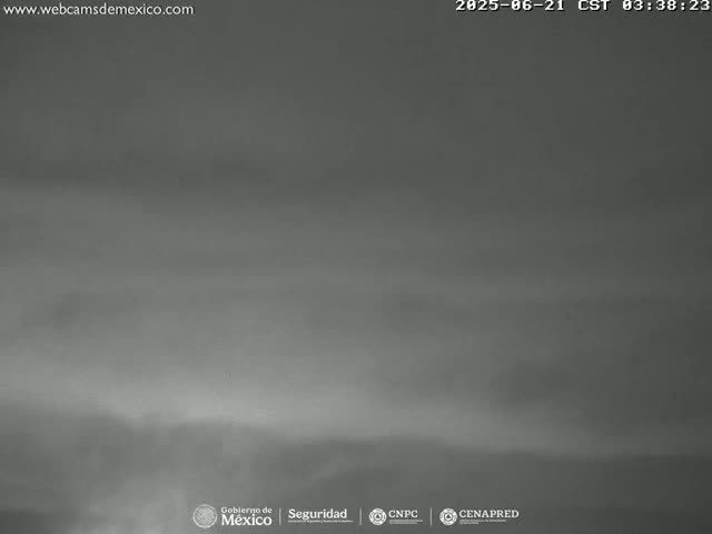 A hazy, overcast sky is visible over a dark, indistinct landscape.