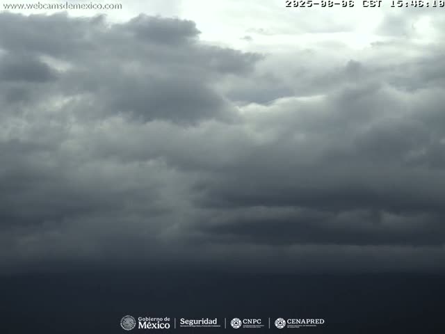 A mostly cloudy sky with dark, heavy clouds covering most of the frame, suggesting an overcast day.