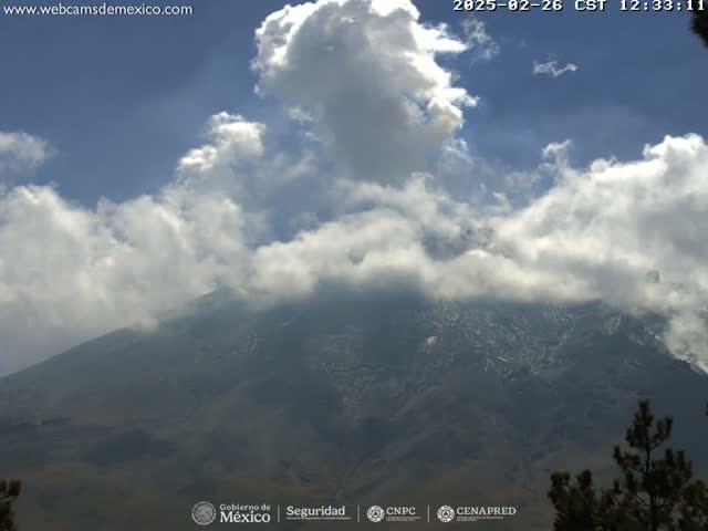 A large mountain partially obscured by partly cloudy skies is visible.