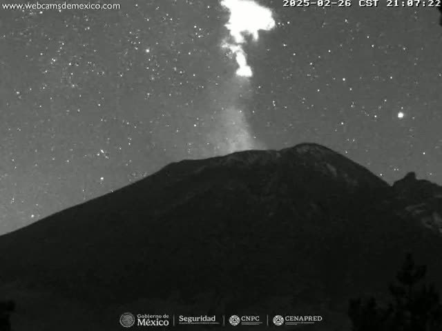 A nighttime, grayscale image shows a volcano erupting under a starry sky.
