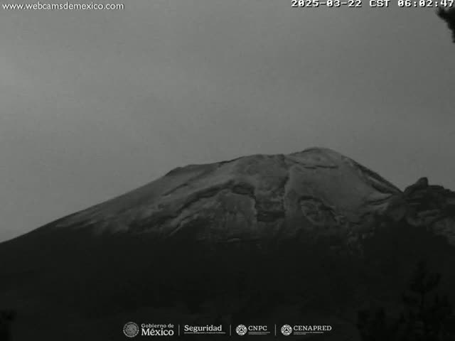 A large, dark mountain is visible under an overcast sky.