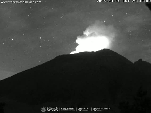 A volcano erupts at night under a starry sky.
