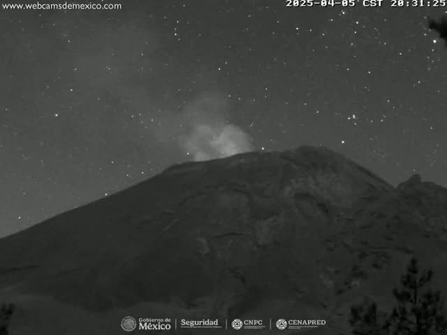 A large, dark mountain with a plume of smoke rising from its peak is visible under a starry night sky.
