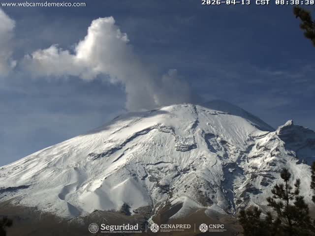 A volcano erupts with a bright plume of smoke or ash against a clear, star-filled night sky.