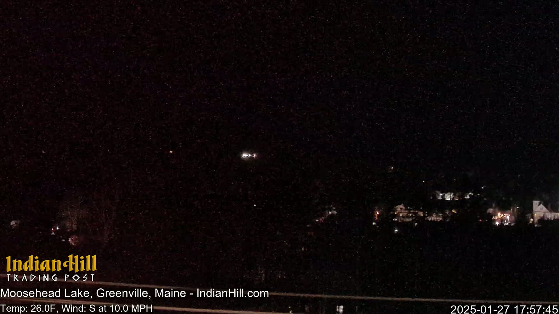 A nighttime, long-range view of a town with a south wind at 10 mph and a temperature of 26°F.