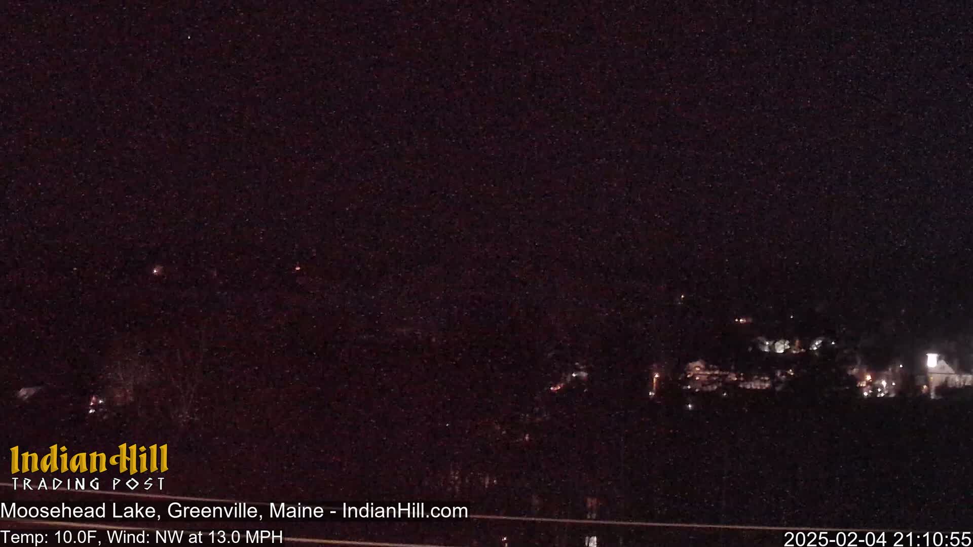 A nighttime long shot shows a dark landscape with a few scattered lights, under a clear, starry sky.