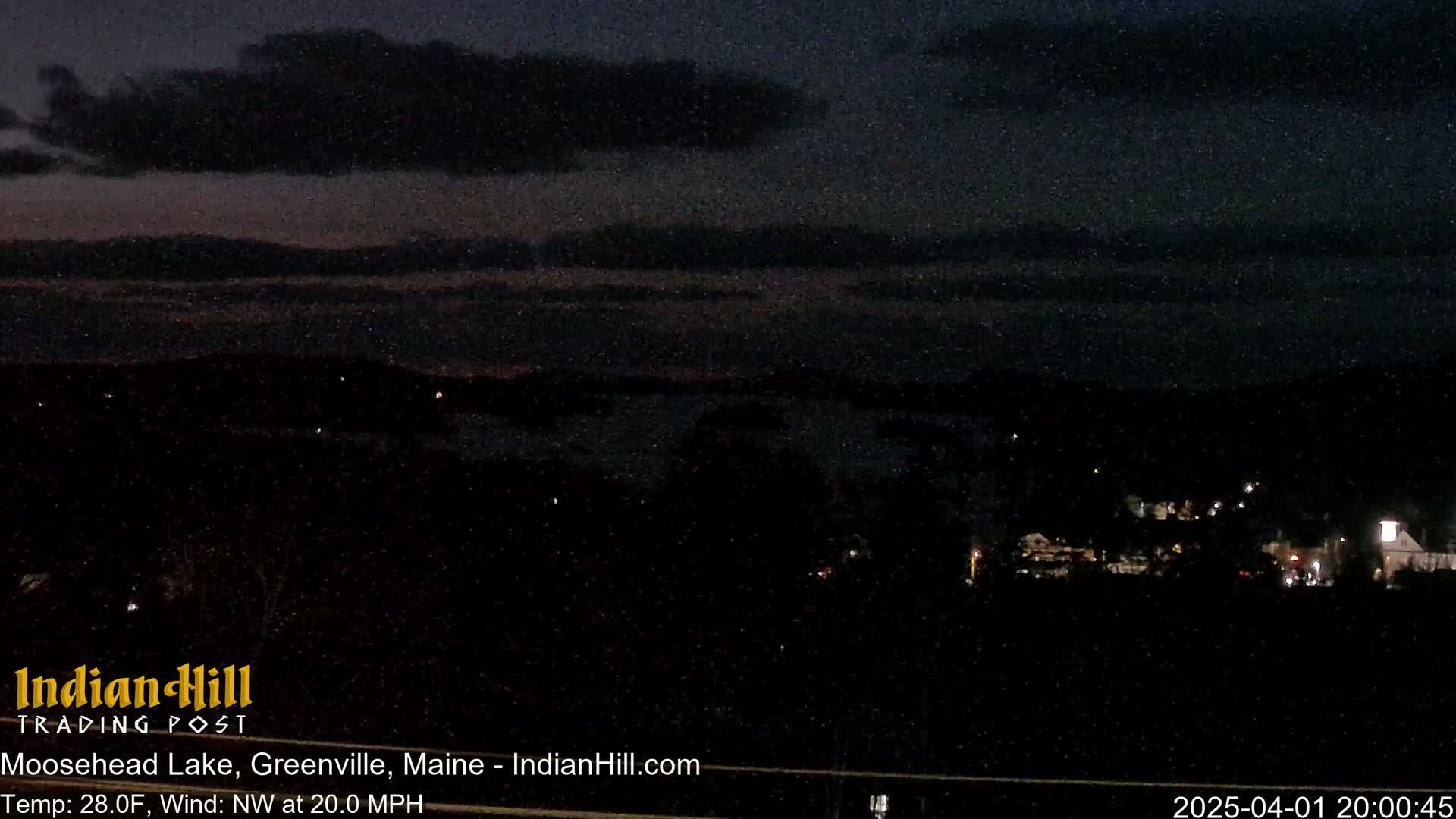 A nighttime view of Moosehead Lake, under a mostly cloudy sky, with a 20 mph northwest wind and a temperature of 28°F.